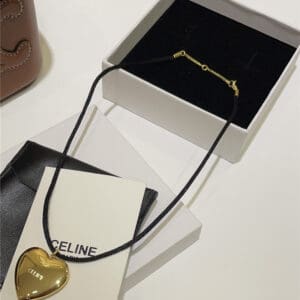 celine golden Arc de Triomphe love pendant black rope necklace